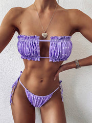 Lavender polka-dot bikini with a ruched frill bandeau top and tie-side bottoms, front view