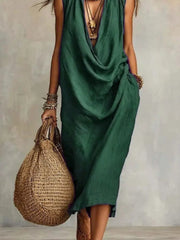 Green draped midi dress showing loose folds and a side pocket