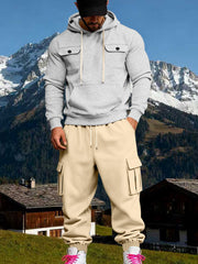 Front view of a model wearing a light grey hoodie with beige cargo sweatpants