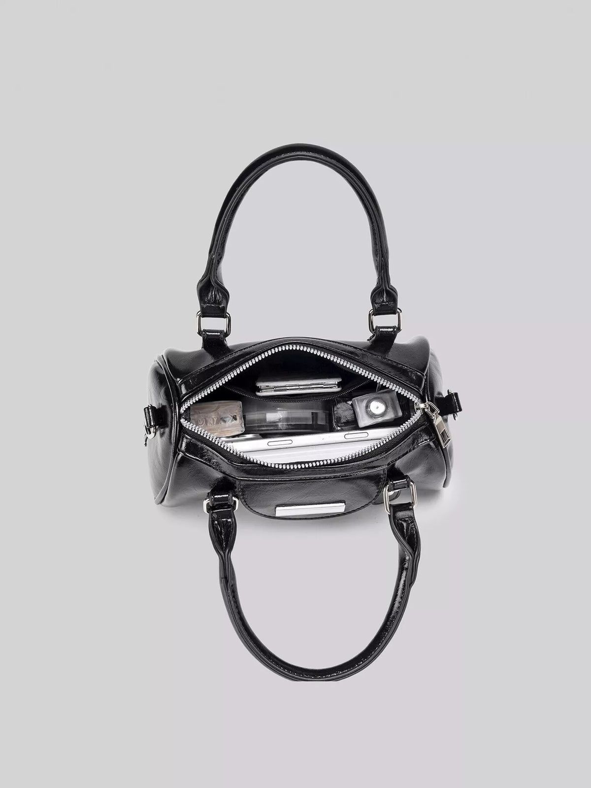 Overhead view into the open black Boston bag, showing its zip closure and interior contents.