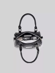 Overhead view into the open black Boston bag, showing its zip closure and interior contents.