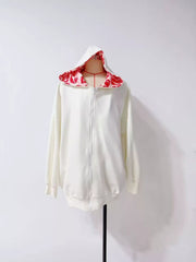 White zip hoodie displayed front-on with red lip-print lining inside hood
