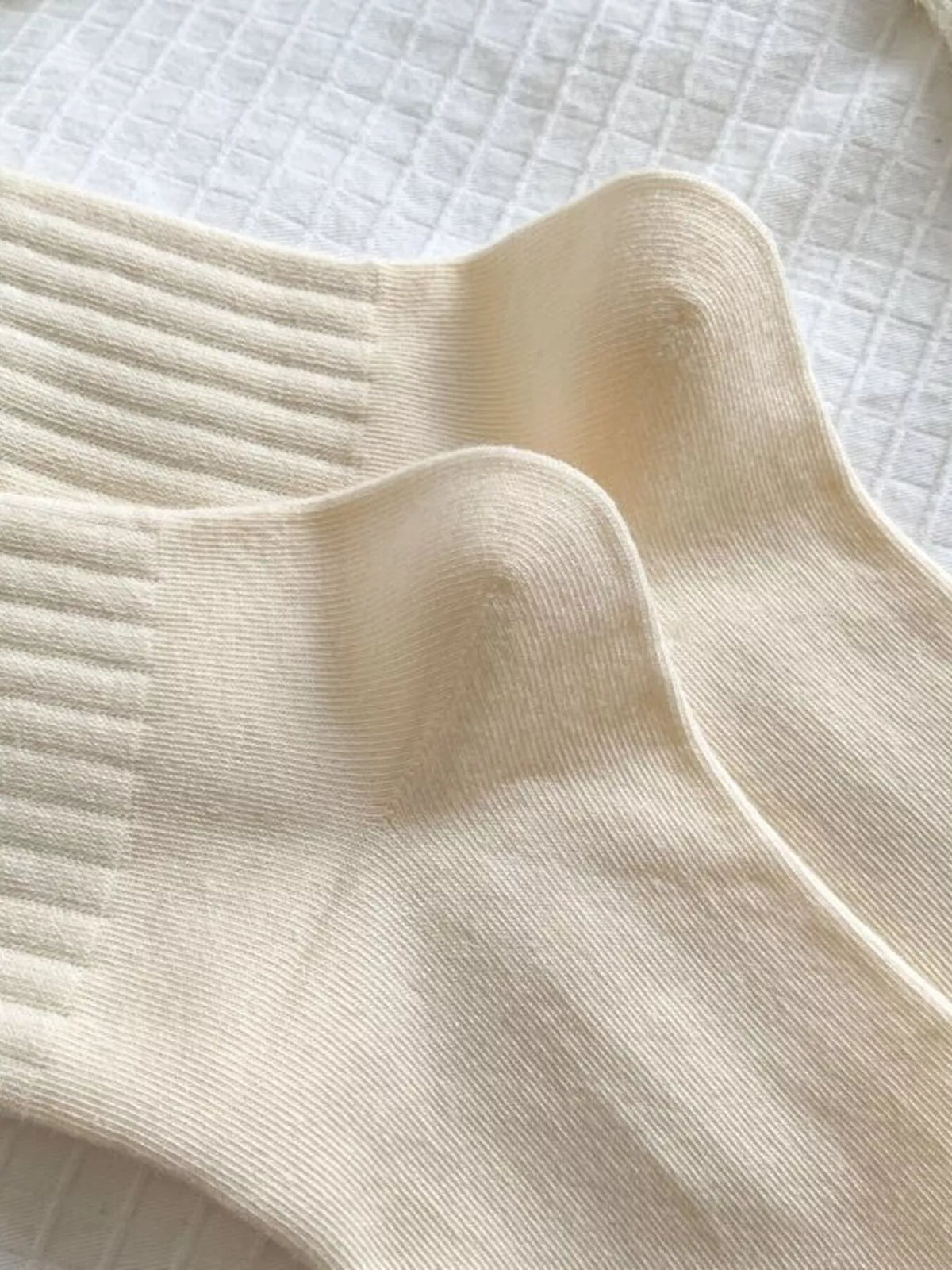 Ribbed cuff and heel detail on cream socks