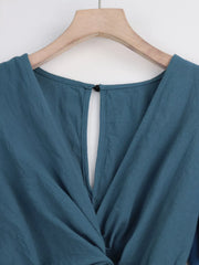 Close-up of haze blue back neckline and button