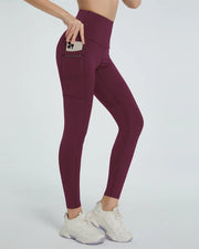 Burgundy high-waisted leggings with side pocket, shown from side