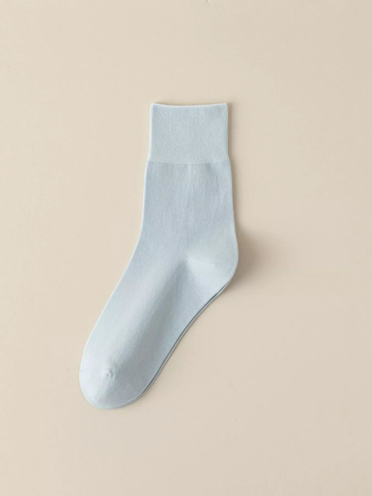 Light blue solid-color crew sock displayed flat