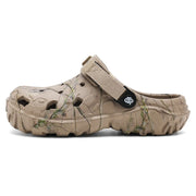 Side profile of a khaki branch-print clog with a deeply textured sole