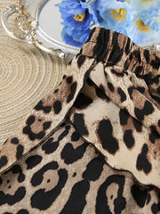 Detail of leopard-print fabric and stitched garment edge