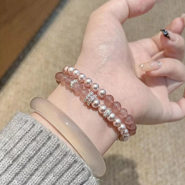 Dusty pink beaded bracelet set held across a hand