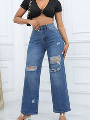 Dark blue ripped wide-leg jeans styled with a black tie-front crop top