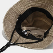 Inside view of khaki bucket hat showing the crown lining and chin cord