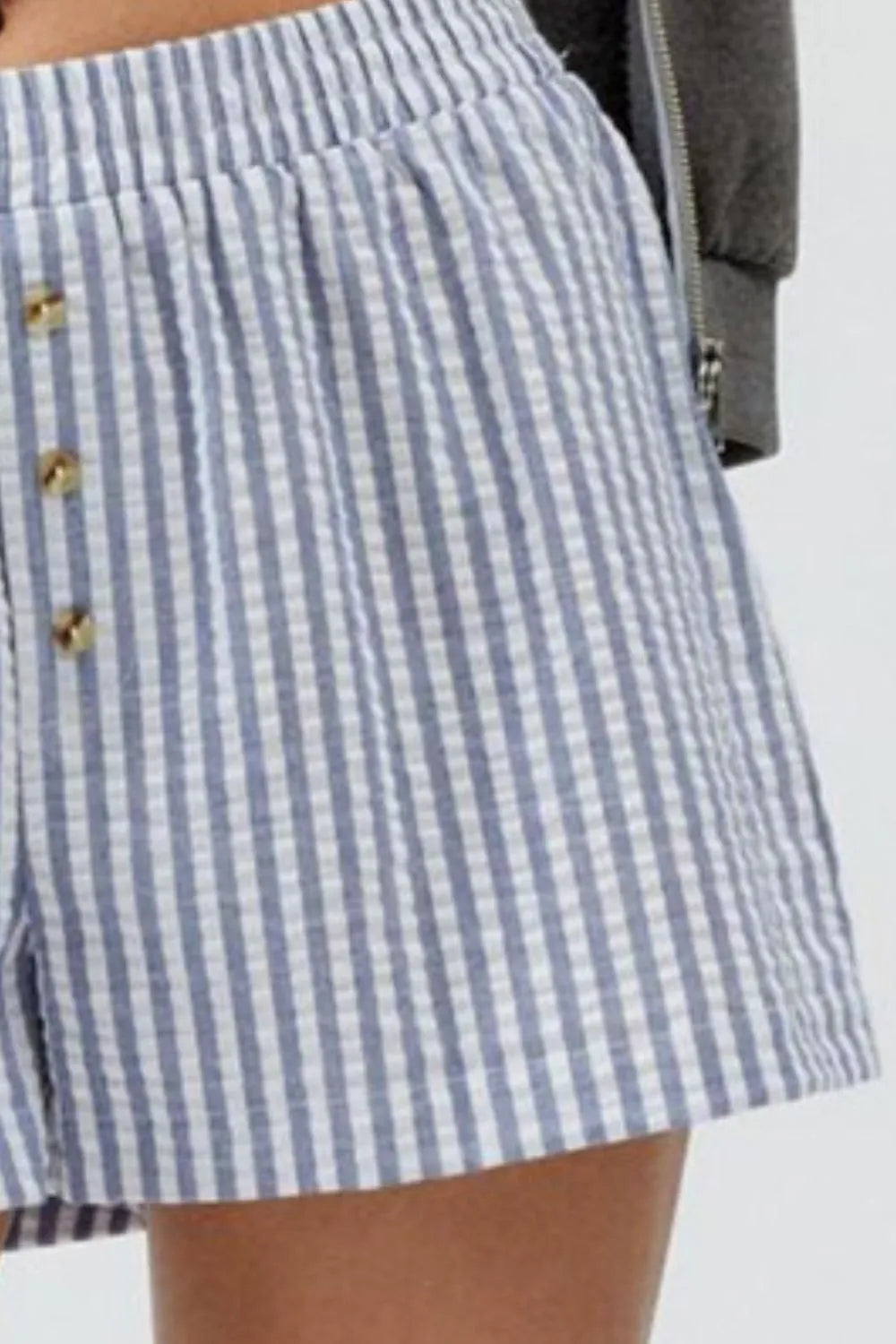 Blue striped shorts showing gathered waist and front buttons