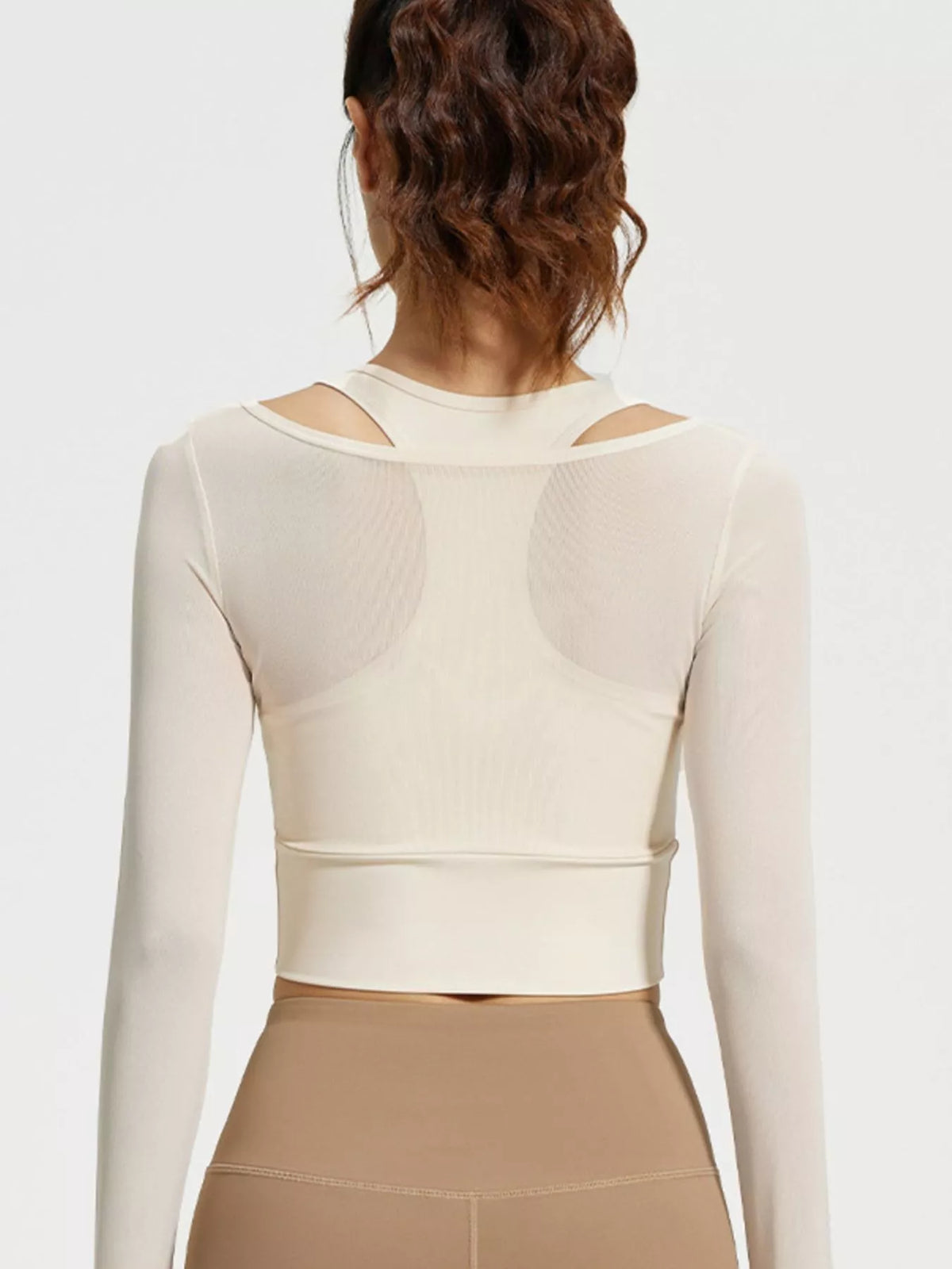 Straight rear view of cream cropped active top with racerback silhouette and wide hem band