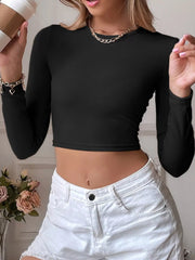 Close view of the black ribbed crop top's fitted neckline and sleeves