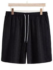 Black textured drawstring shorts, front view