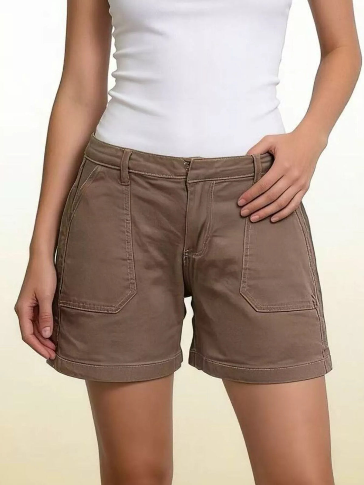 Brown denim shorts with large front patch pockets and belt loops, front view