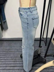 Side-rear view of light blue wide-leg jeans showing a back pocket and straight side seam