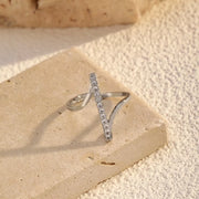 Silver-tone irregular open ring with rhinestone-set diagonal bars on a stone block