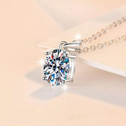 Close-up of round moissanite pendant in silver setting