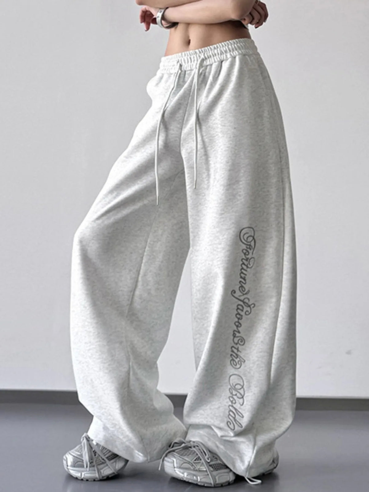 Light gray wide-leg drawstring pants with script leg print