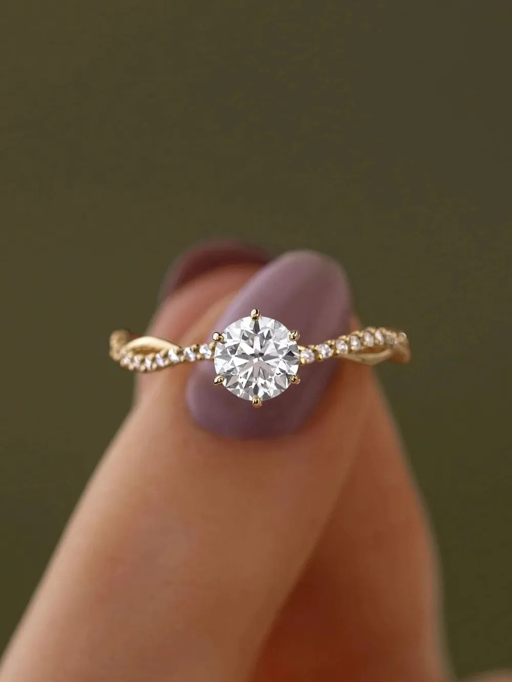 Close view of the ring's raised zircon center between fingers