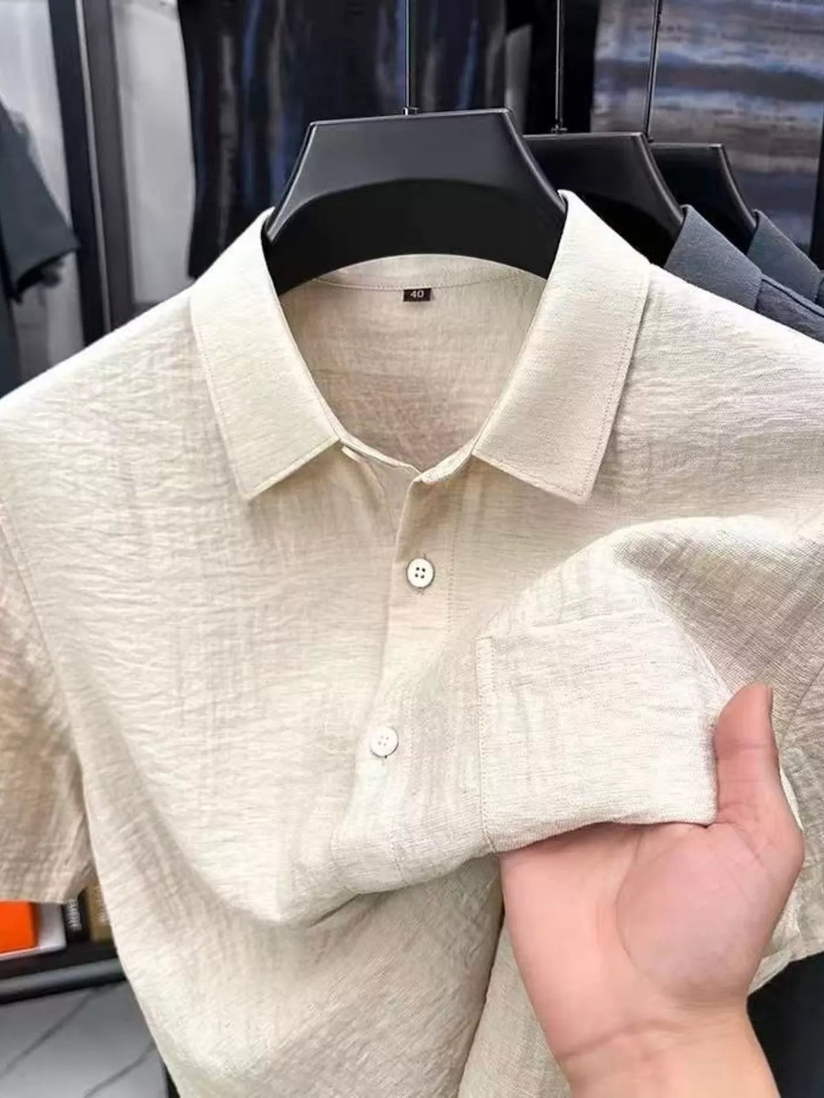 Close view of the cream shirt collar, buttons and chest pocket