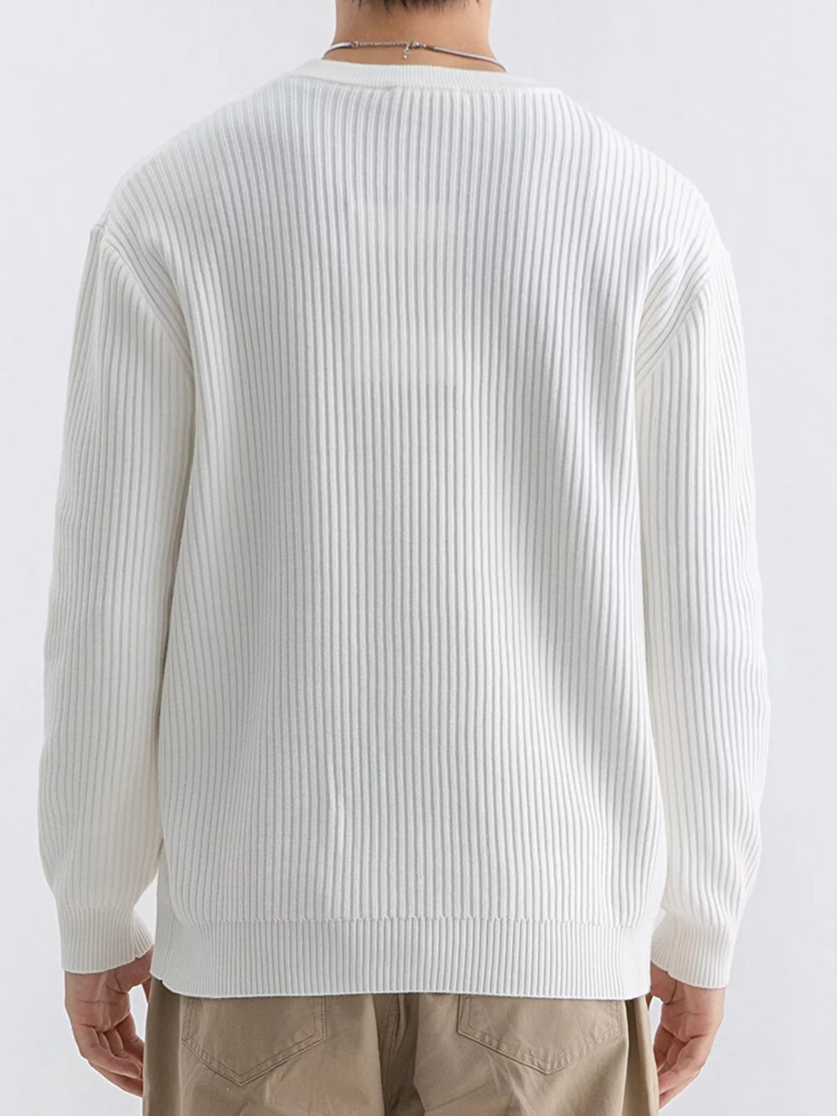 Back view of ivory sweater showing vertical ribs and dropped shoulder seams