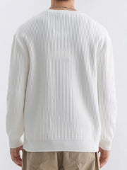Back view of ivory sweater showing vertical ribs and dropped shoulder seams