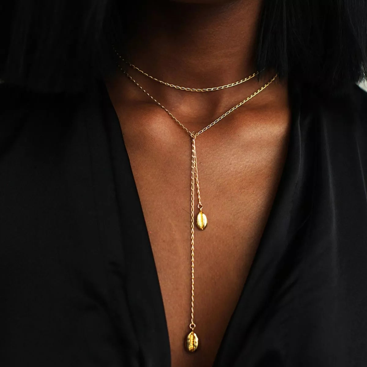 Gold-plated Y necklace with two vertical oval charms worn over a black top