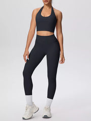 Front view of black halter-neck crop top and leggings