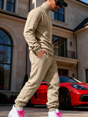 Beige cable-knit sweater and joggers shown from the side.