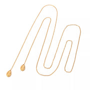 Full length of the gold Y-shaped necklace laid out on white