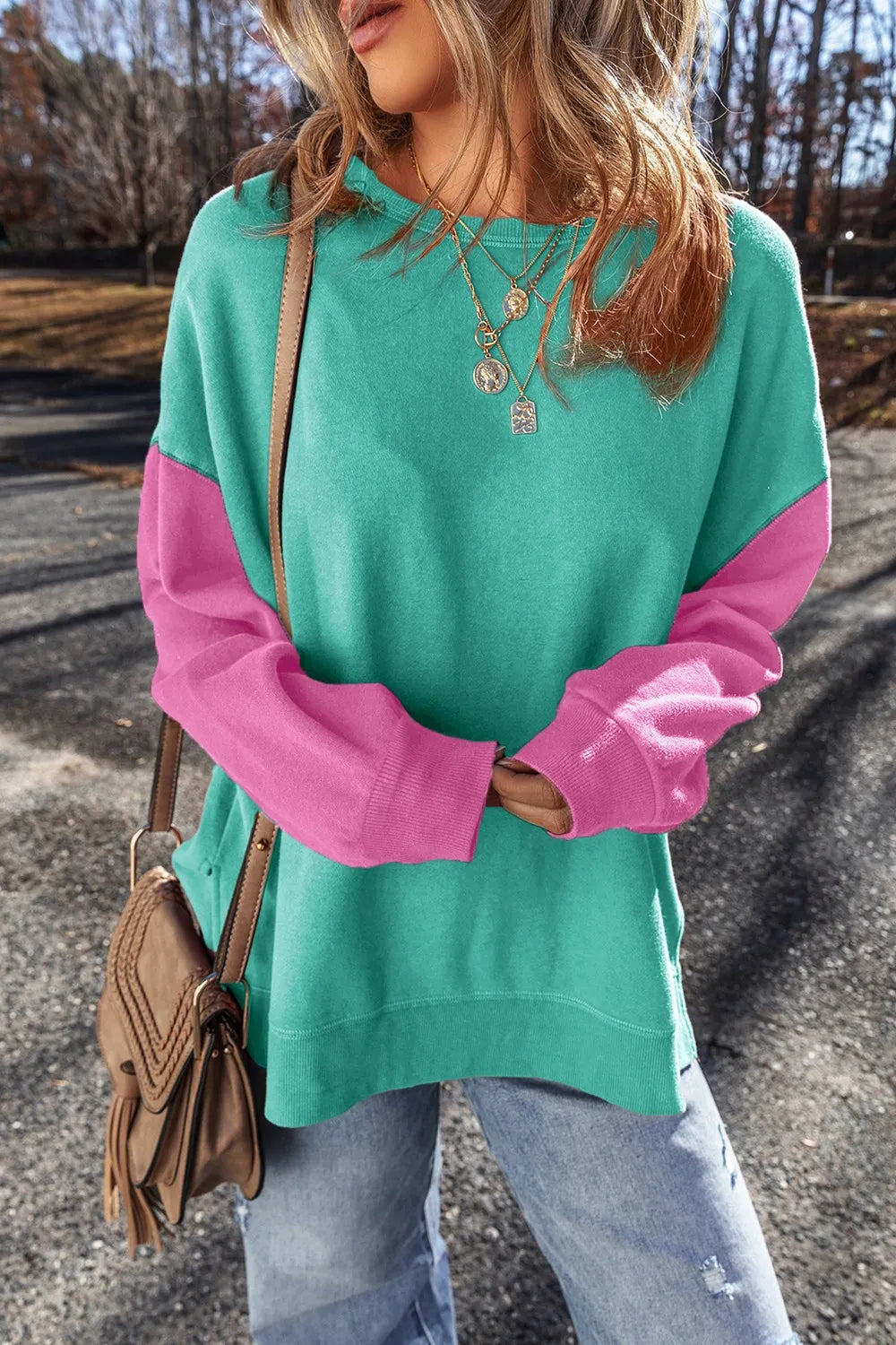 Close view of turquoise sweatshirt and pink sleeve