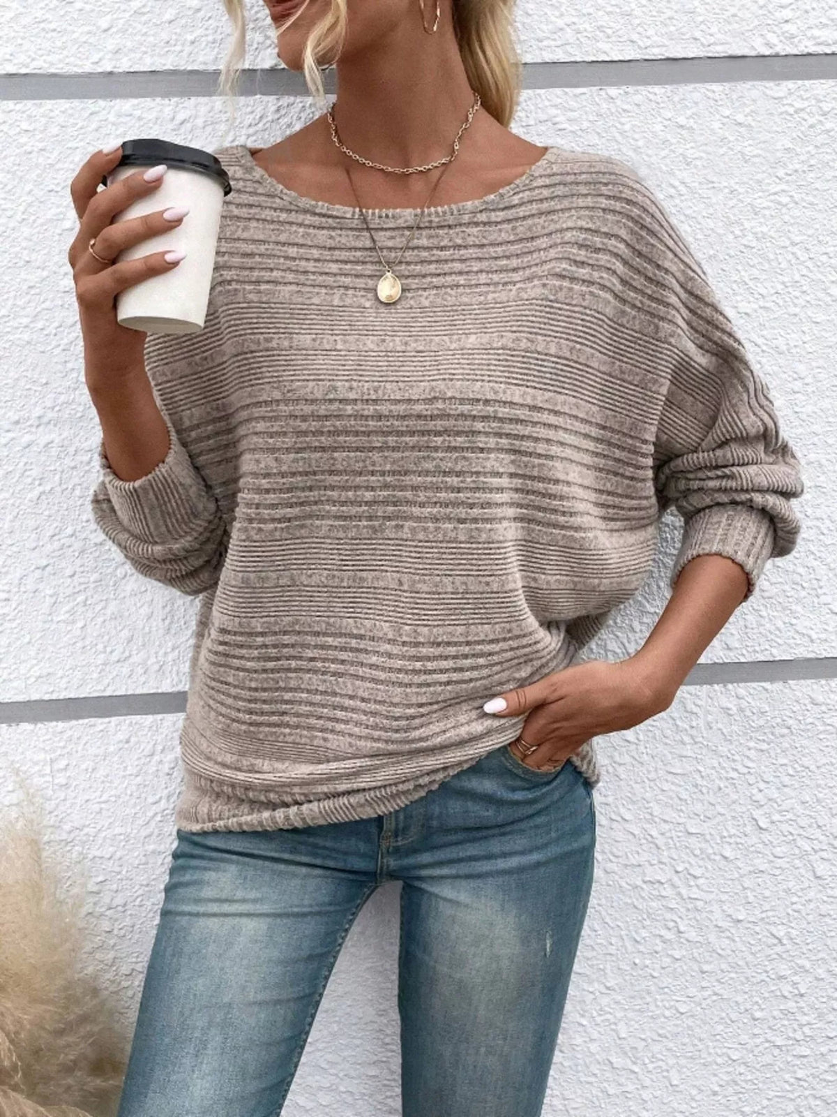 Women’s ribbed round-neck long-sleeve top in taupe front view holding cup