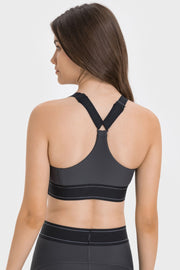 Back view of charcoal contrast sports bra with crossed racerback straps