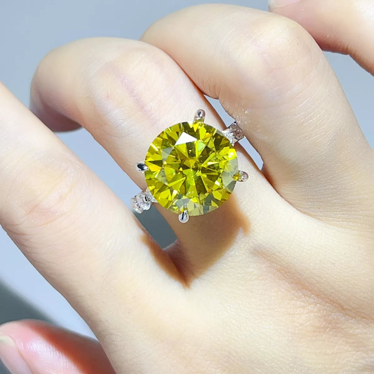 Yellow centre-stone ring worn on hand