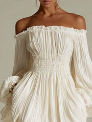 Close view of the white dress's pleated bodice, off-shoulder neckline, and smocked waist