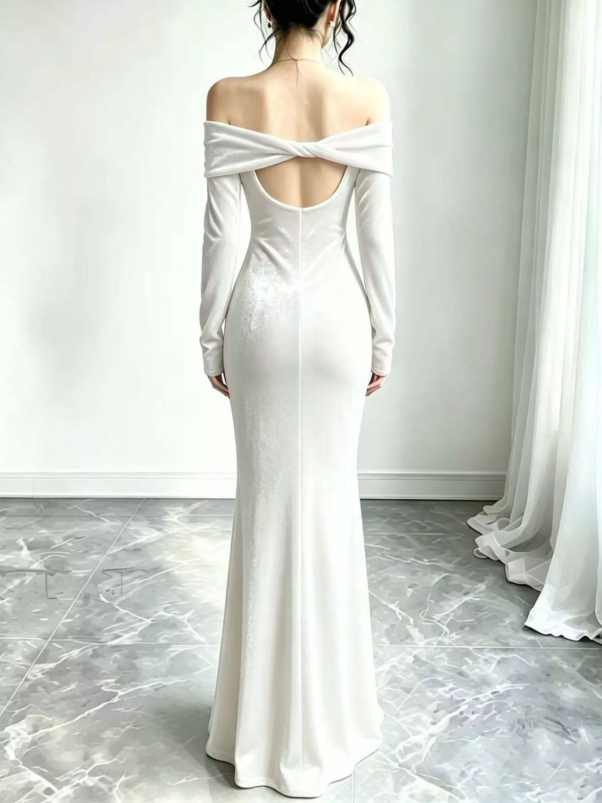 White velvet maxi dress showing the open back and crossed straps