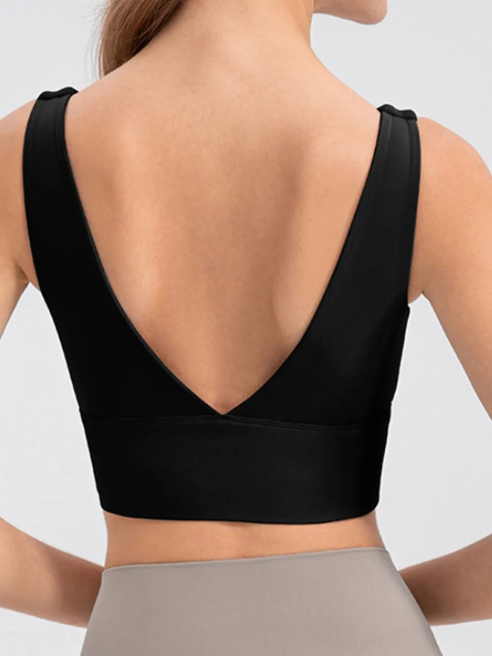 Black cropped tank worn with leggings, angled front view