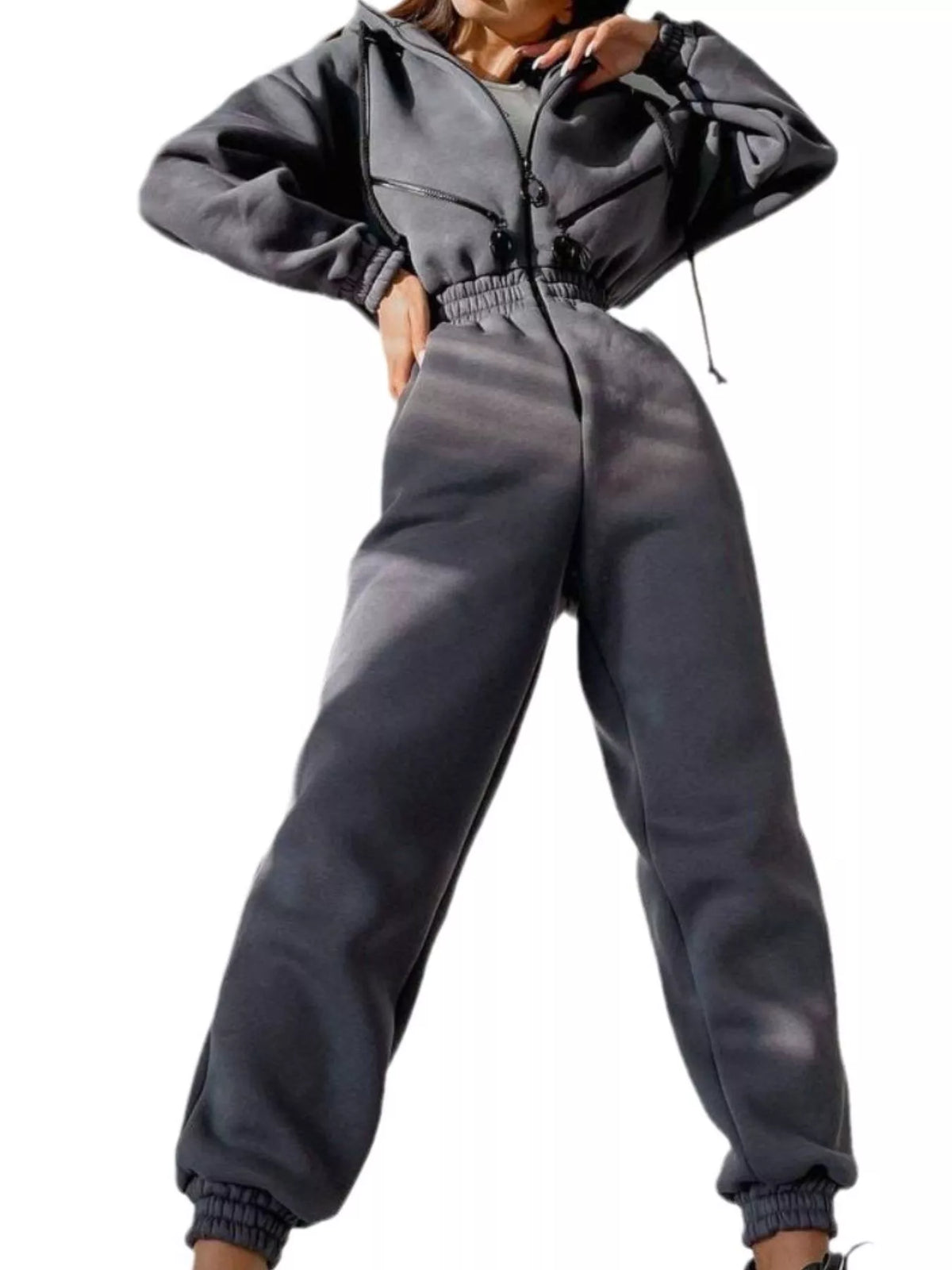 Women's charcoal hooded jumpsuit, model side pose with arm extended