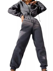 Women's charcoal hooded jumpsuit, model side pose with arm extended
