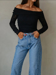 Full outfit view of black off-shoulder top with jeans
