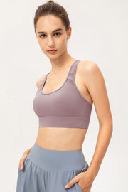 Model wearing mauve sports bra, angled front view