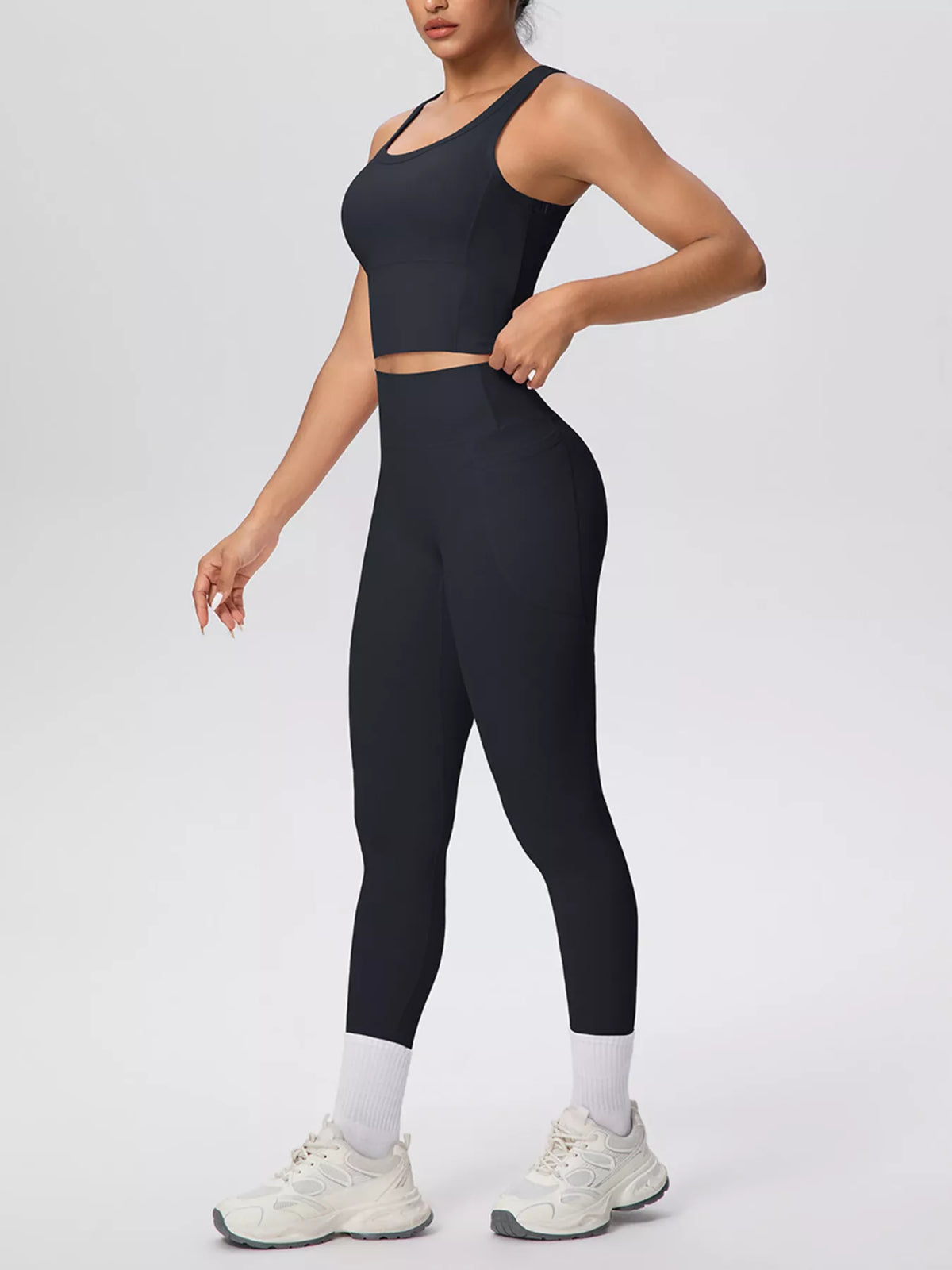 Black tank and leggings posed in a side view