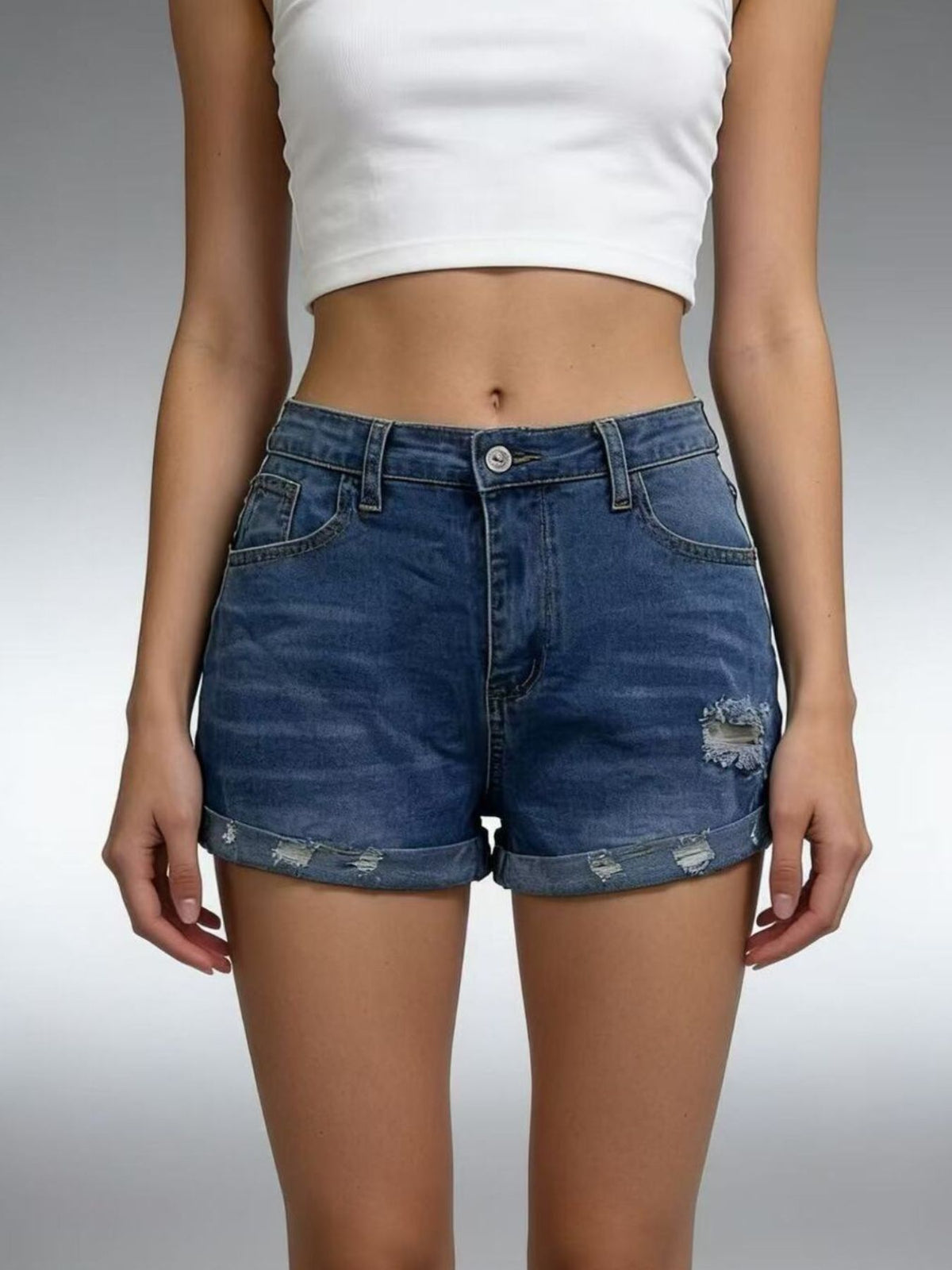 Model wearing medium-blue denim roll-up shorts