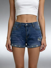 Model wearing medium-blue denim roll-up shorts