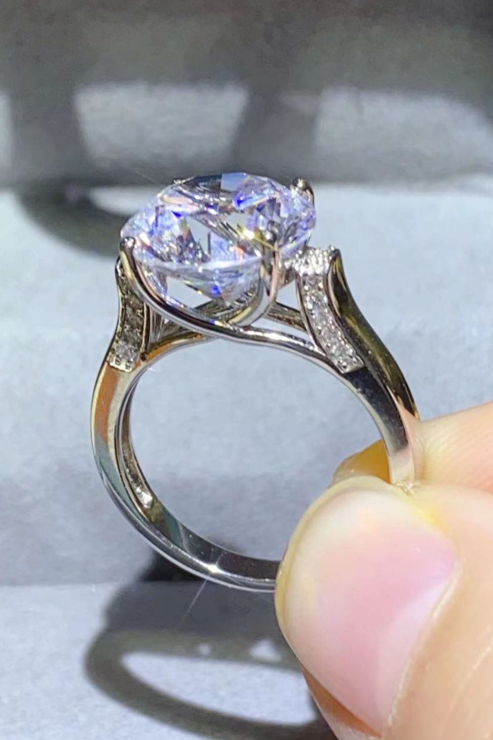 Close side view of the solitaire ring and its elevated prong setting.