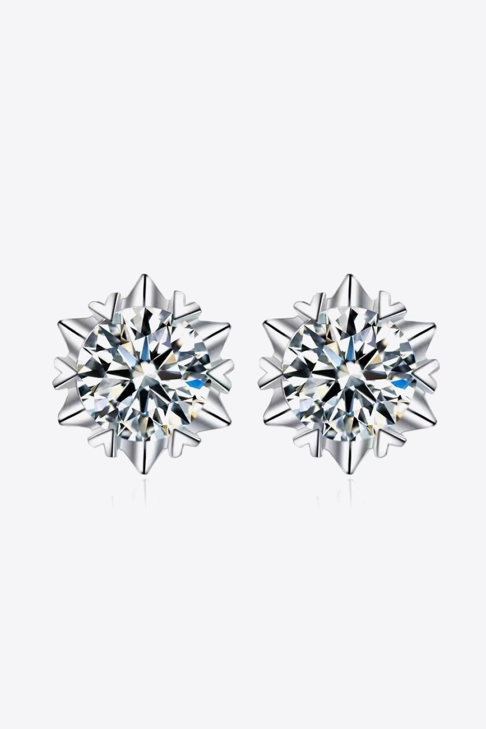 Front view of round clear-stone stud earrings with pointed silver-tone surrounds