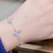 Butterfly chain bracelet with clear stones worn around a wrist
