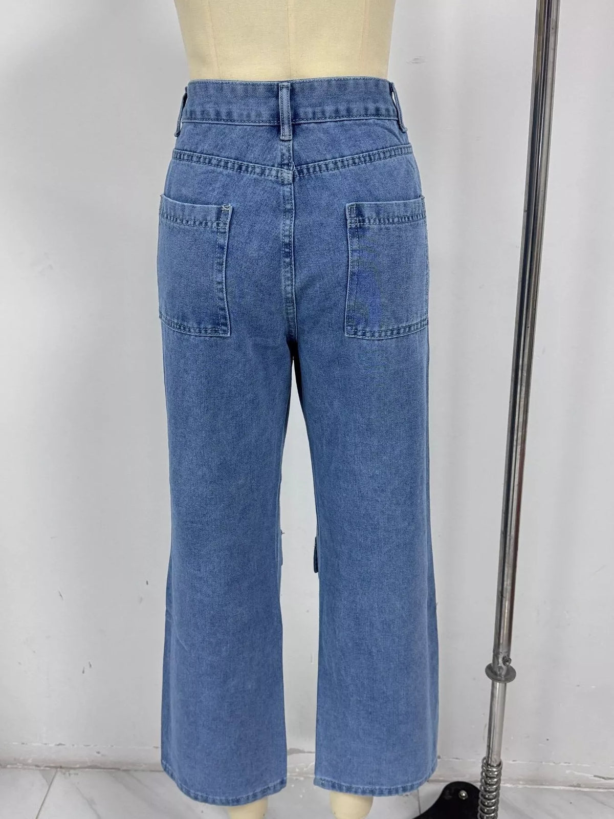Blue cargo jeans shown from the back with two patch pockets
